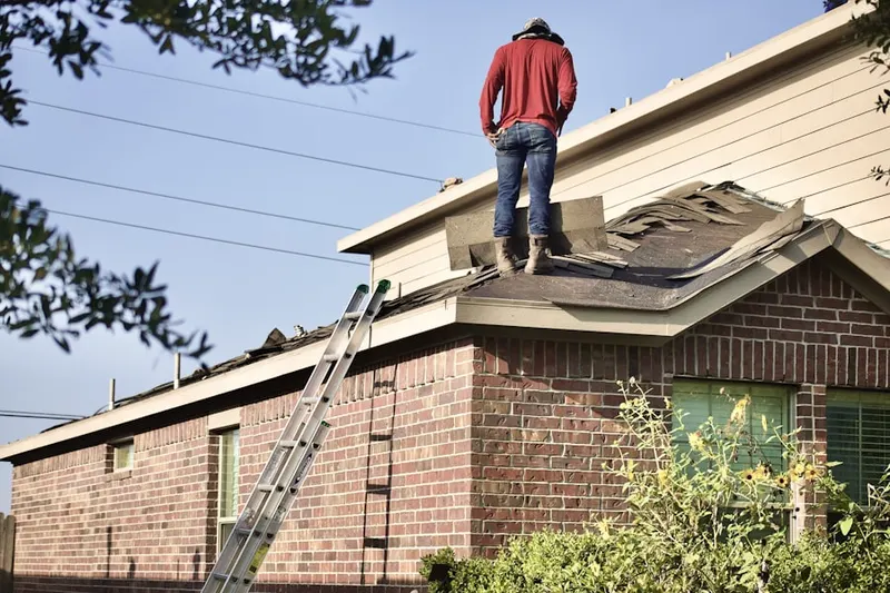 Professional roofer working on a residential roof in Myrdell Estates
